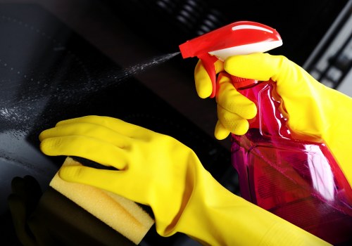 Cleaner in PPE working safely during carpet cleaning in Kennington